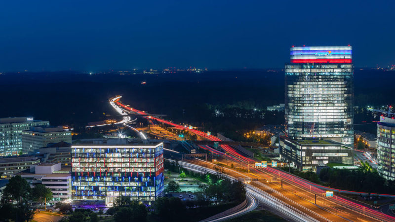 The Capital One building in Fairfax, VA is lit up at night in red, white and blue